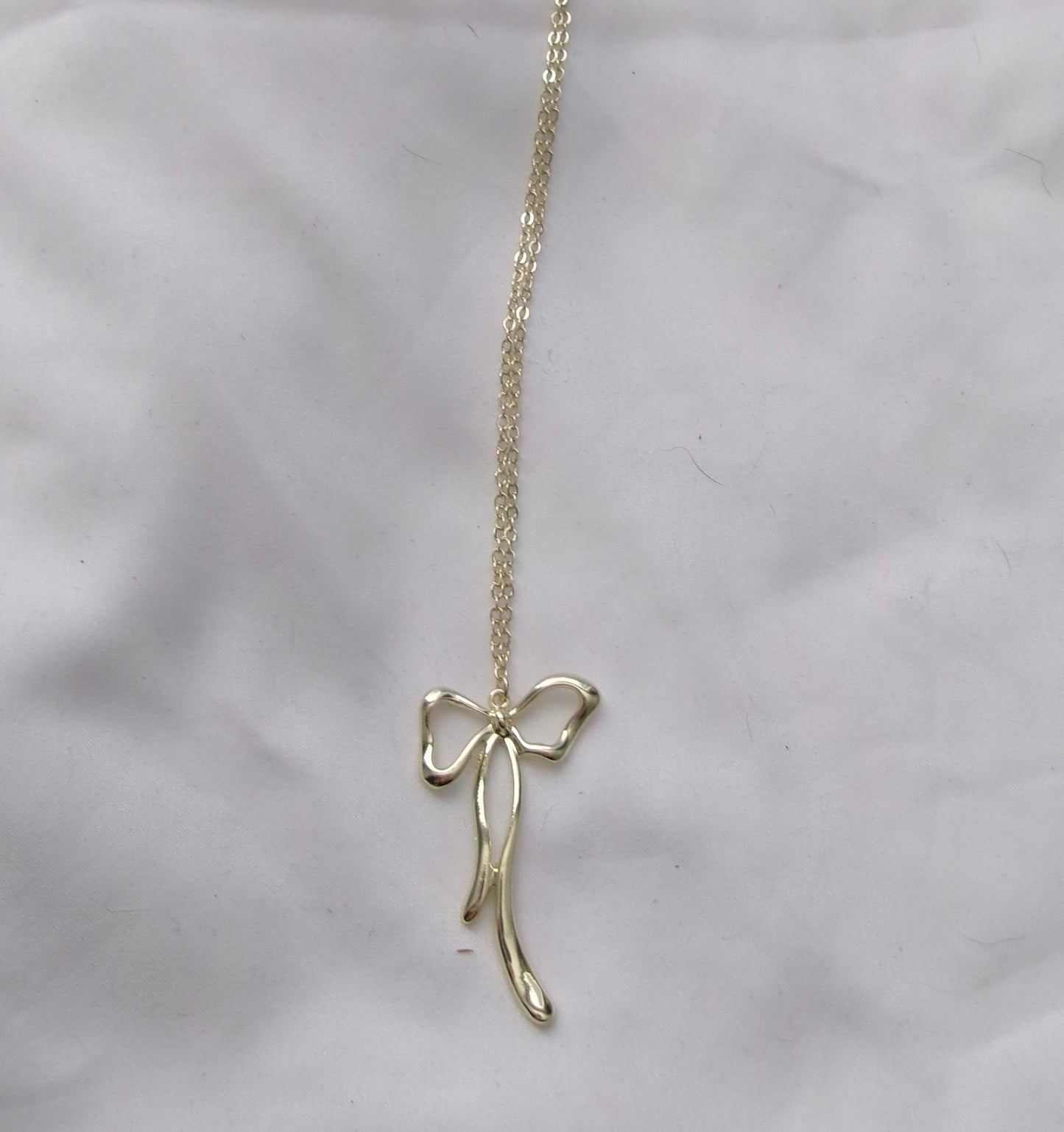 new gold long bow necklace