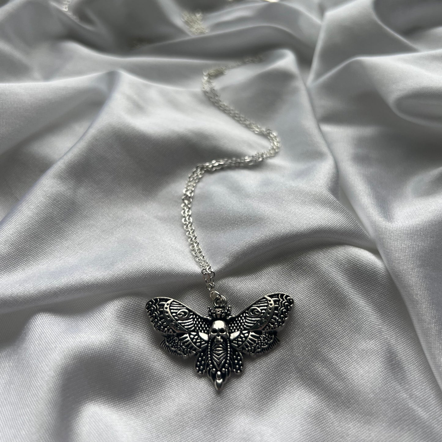 skeleton moth necklace